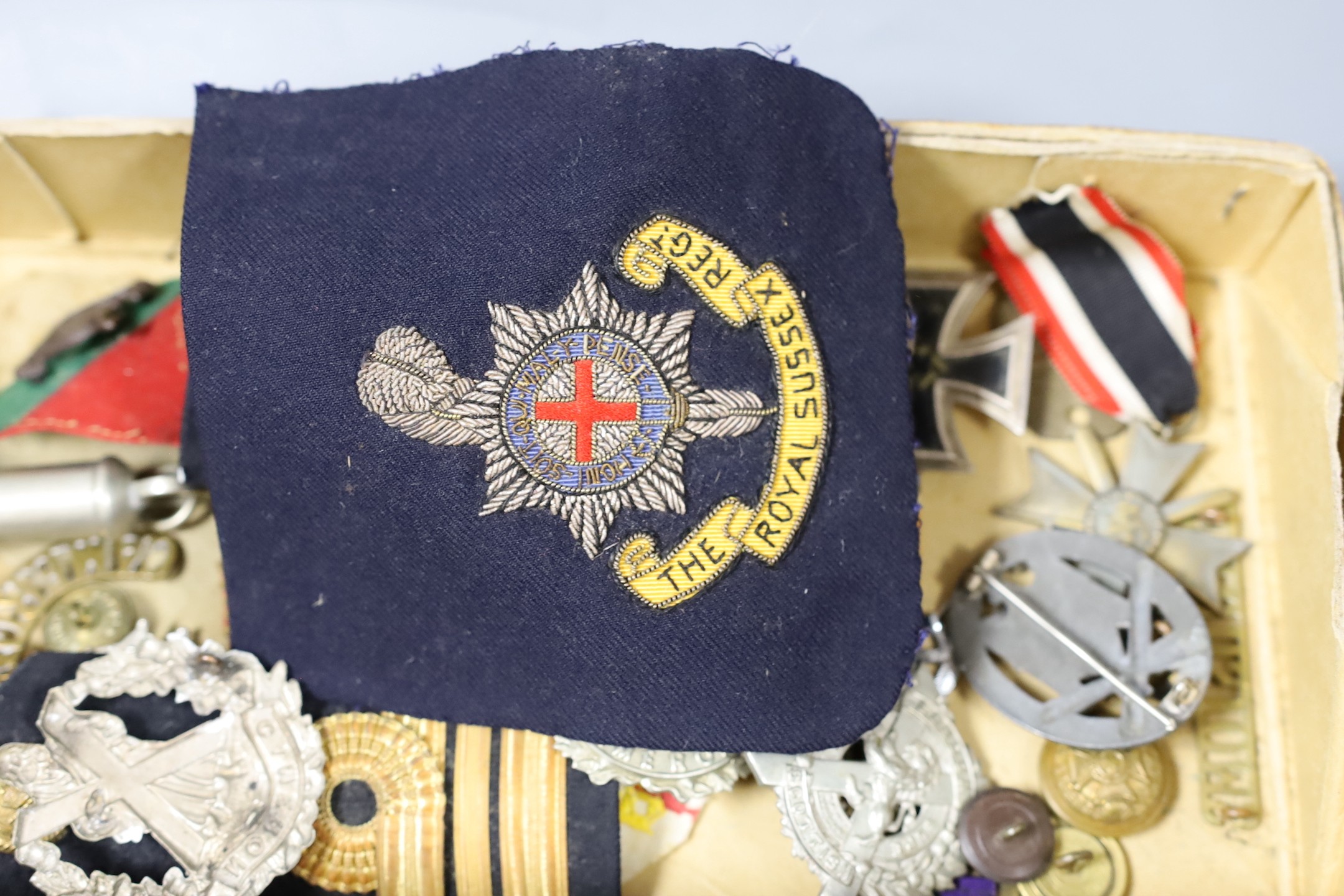 A mixed collection of German Third Reich and other military badges and buttons